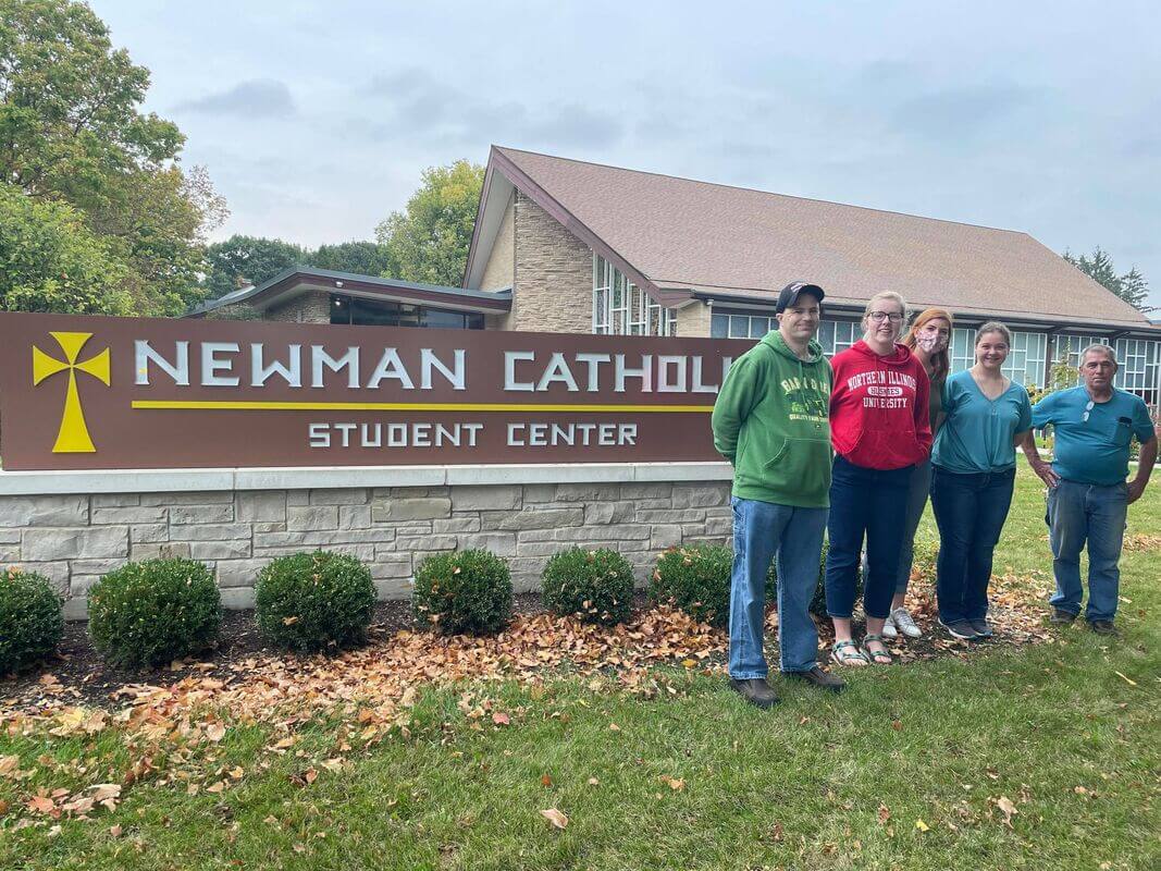 Opportunity House clients posing in front of their workplace.