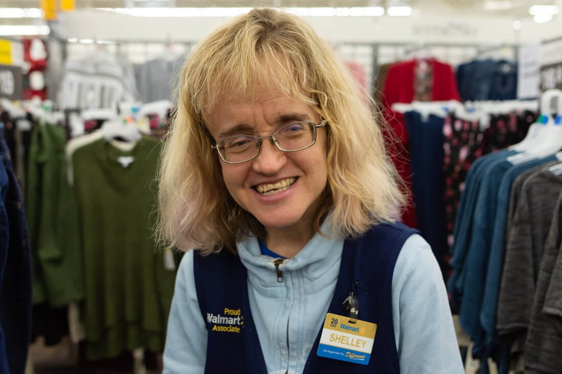 Opportunity House client smiling at their workplace during the workday.