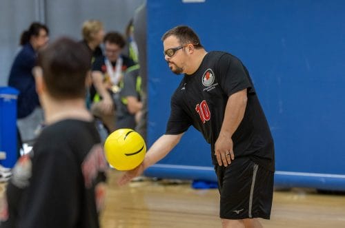 Opportunity House athlete about to spike the ball during a volleyball event.