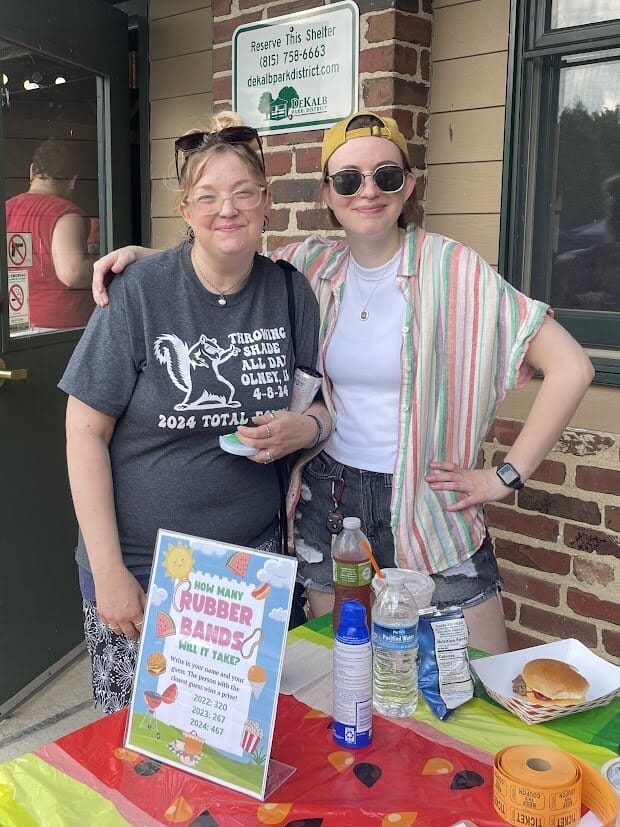 Two volunteers smiling while attending the OH Watermelon Explosion.