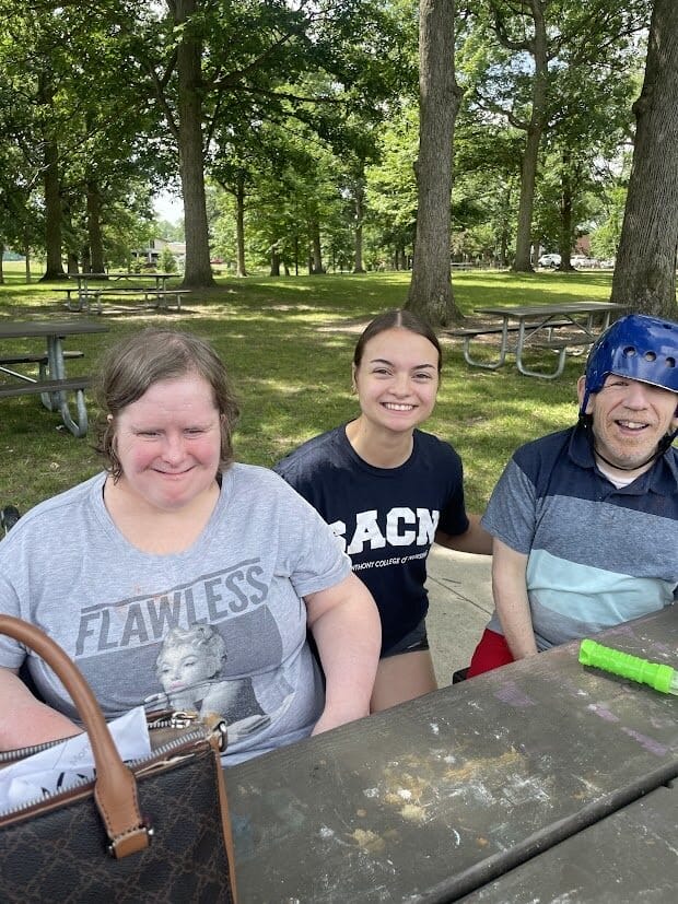 OH clients and particpant smiling together while outside at the Watermelon Explosion event.