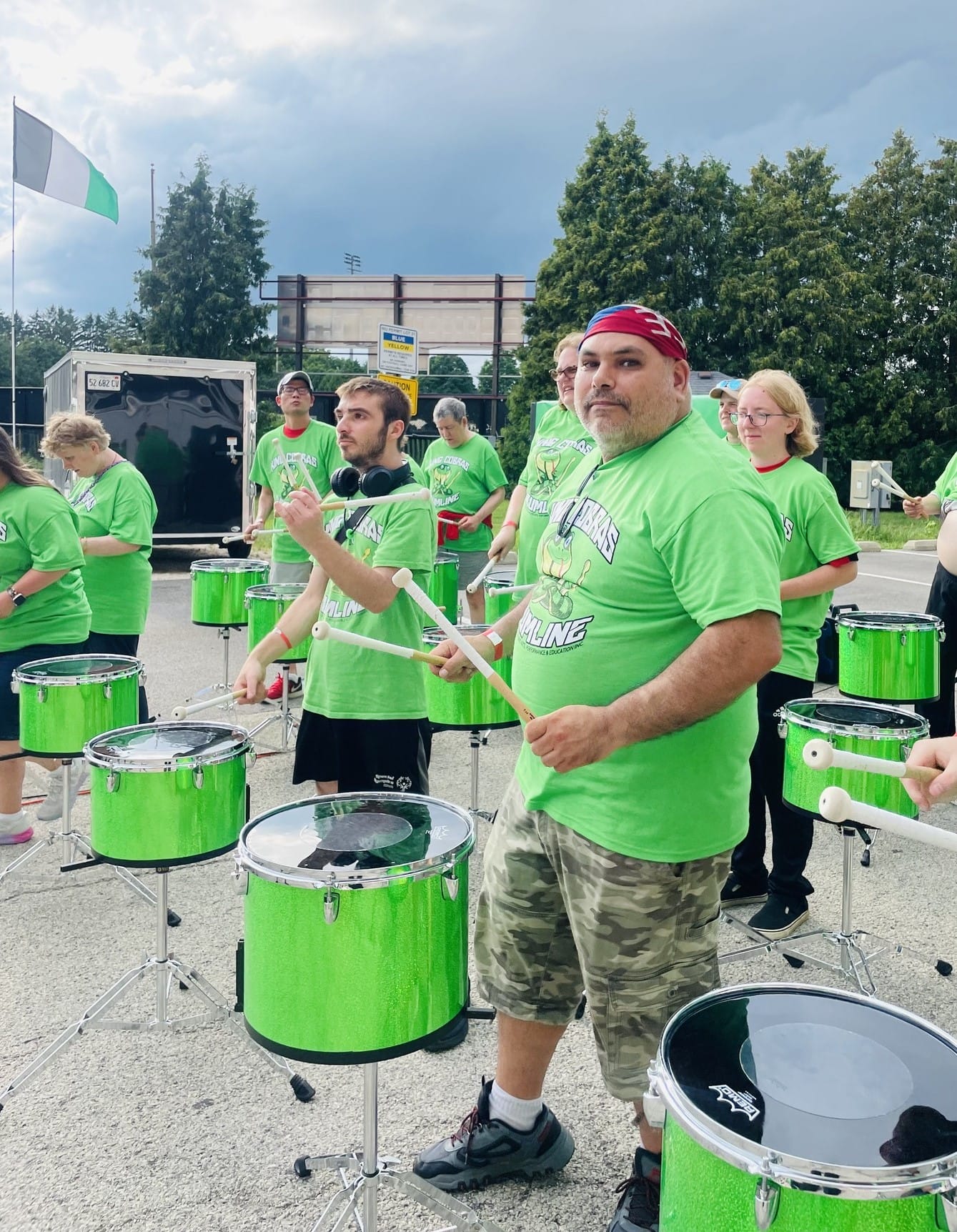 Opportunity House Recreation clients playing drums with the King Cobras Drumline.