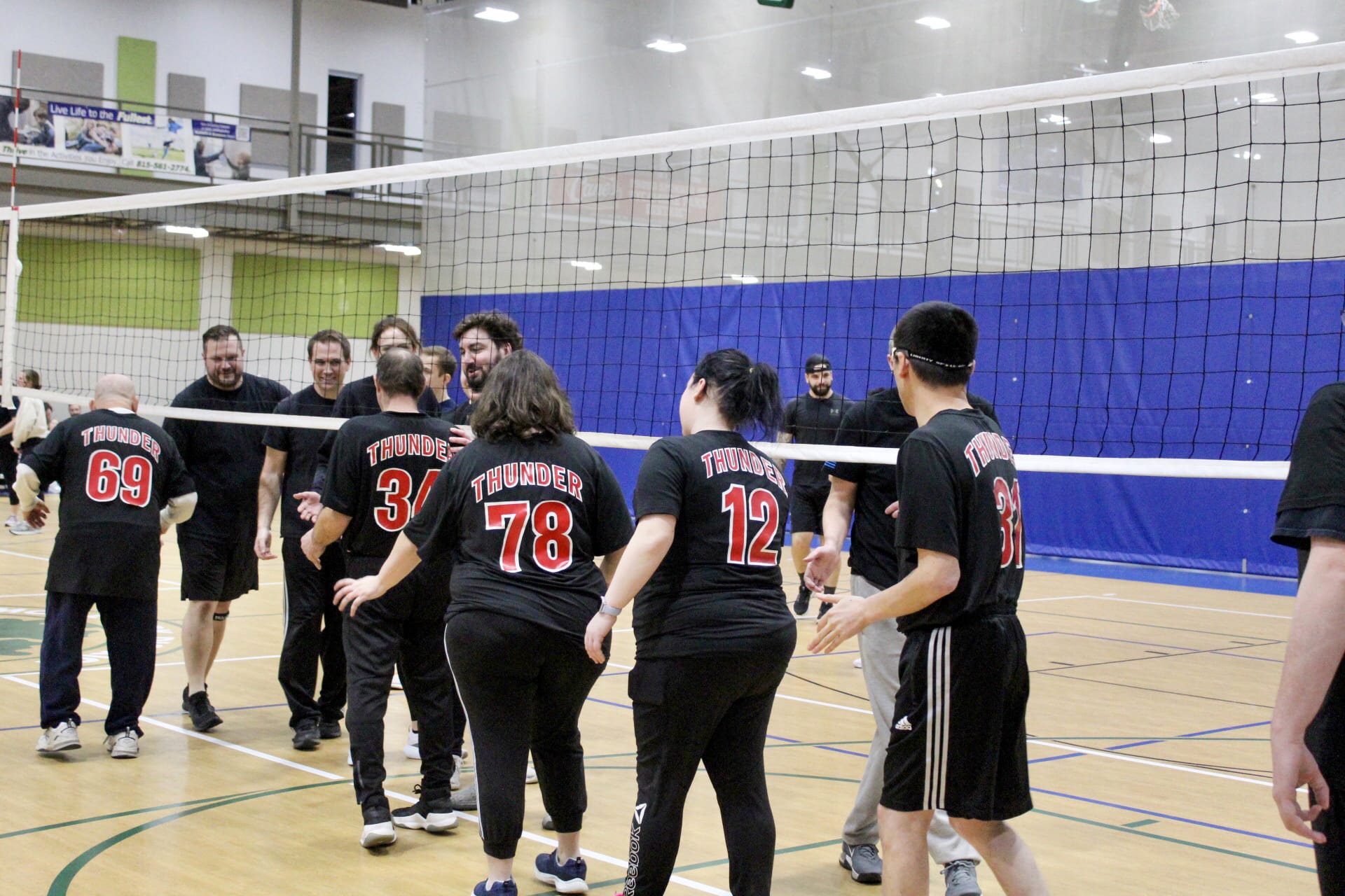 Opportunity House Athletics Volleyball Team ending match by lining up and shaking hands.