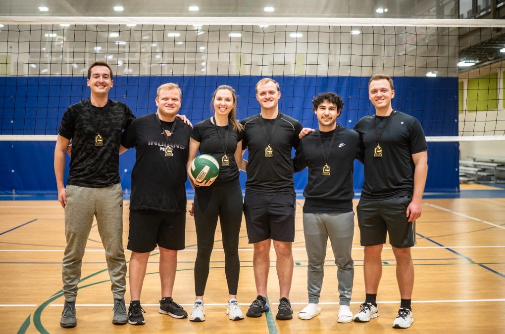 Pool B Volleyball Team Winners posing with medals.