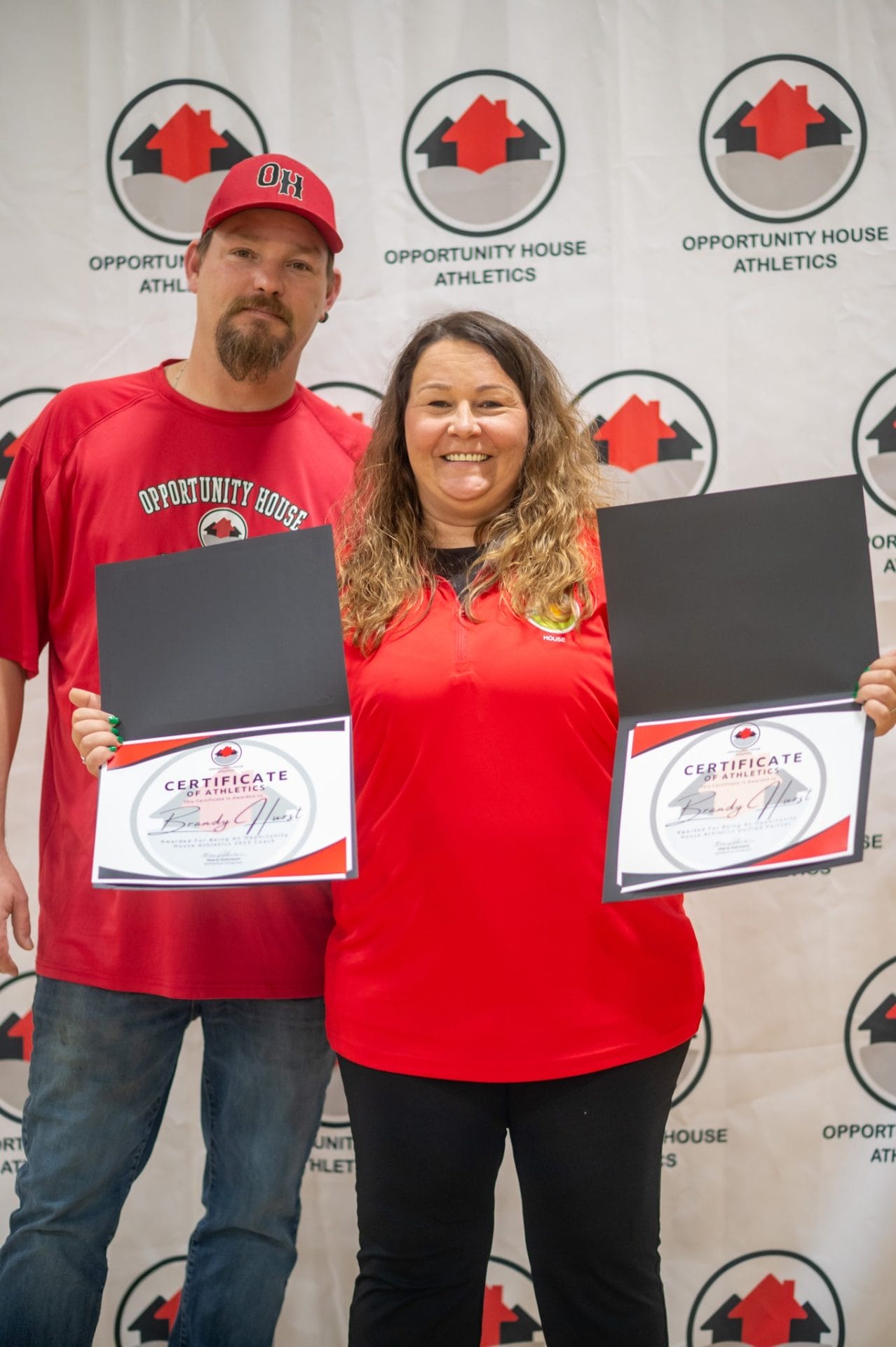 2 Opportunity House Athletics Coaches showing Certificate of Athletics Certificates