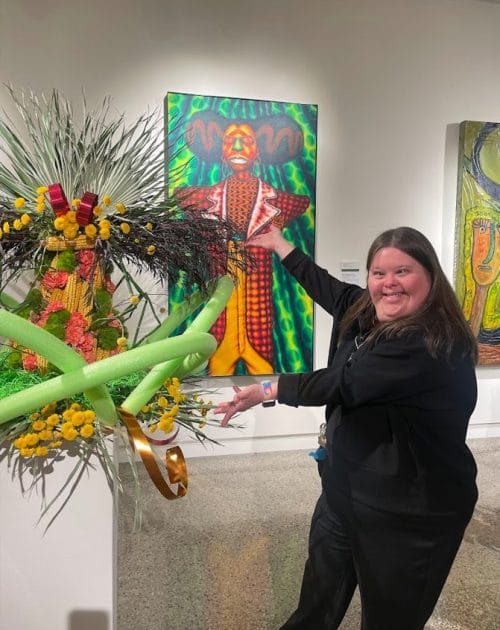 Opportunity House client showing off art work