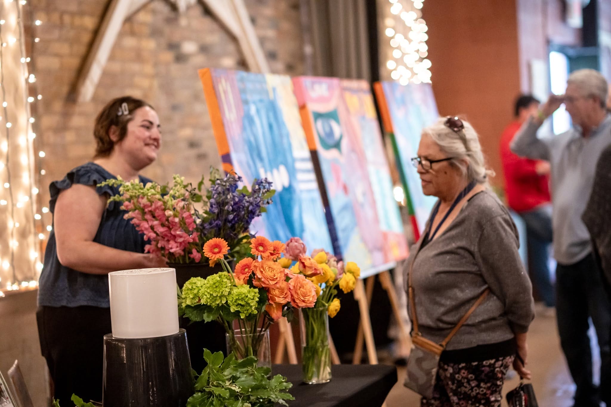 OH Staff member looking at flower bouquets.
