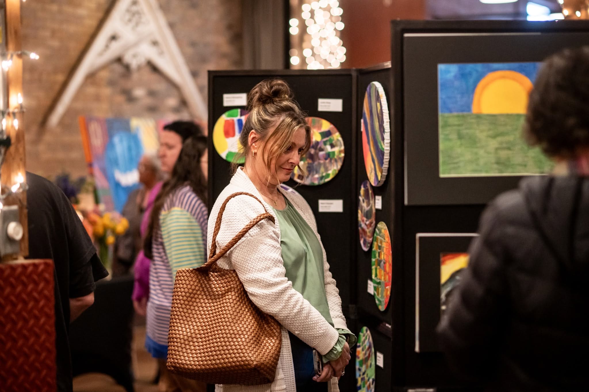 Attendee looking at art work display.